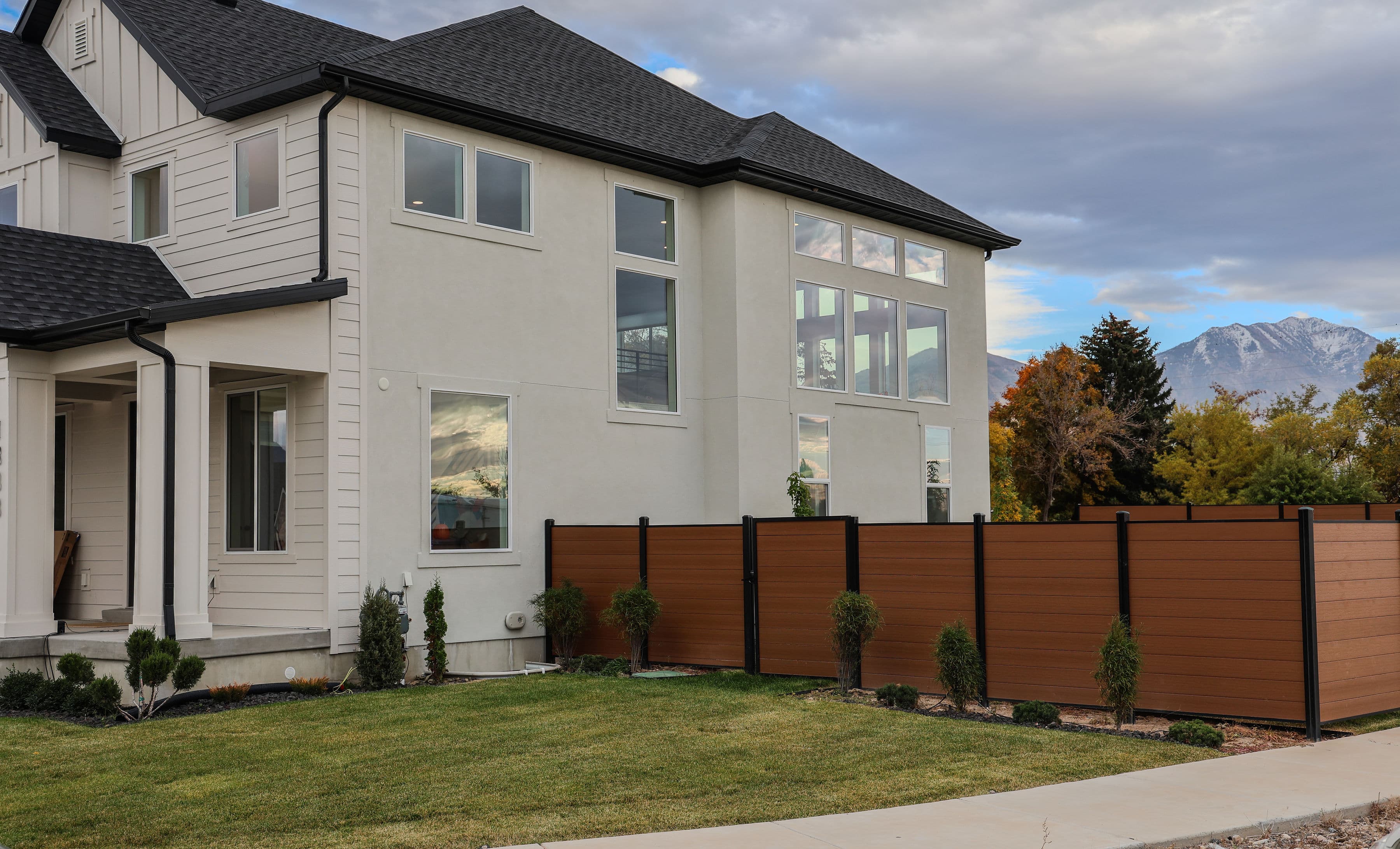 Composite fence next to a board-on-board wood fence