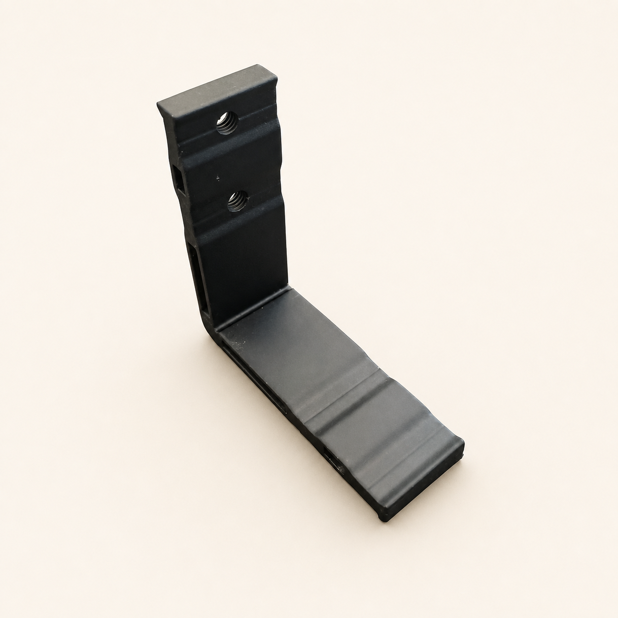 Black Compoxen rail bracket on a warm studio background